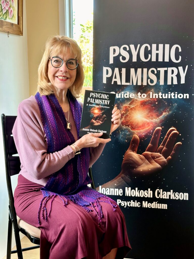 A photo of Joanne with the Psychic Palmistry book